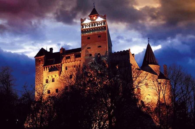 Bran Castle floodlit above the Transylvanian treeline